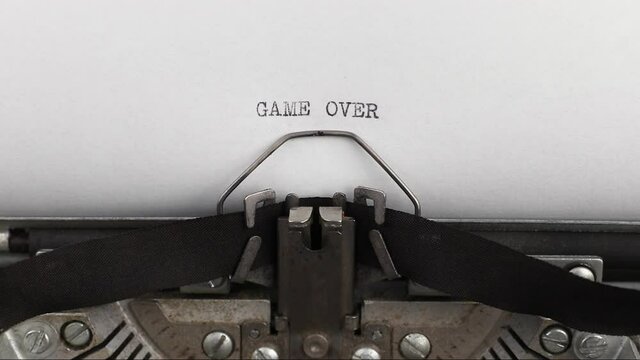 to type quote game over on a vintage and old typewriter close-up
