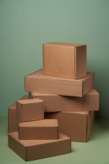 Stack of cardboard boxes on pastel color background with copy space