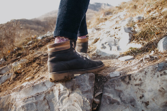 Close-up photo of feet walking in the mountains.