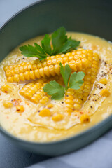 Gazpacho made of sweet corn, yellow tomatoes and bell peppers, close-up, vertical shot