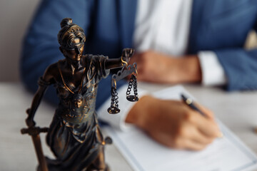 Lawyer office. Statue of Justice with scales close-up and lawyer. Legal law, advice and justice concept.