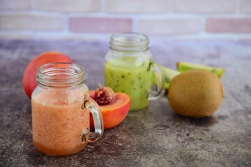 Fresh peach and kiwi juice in jars