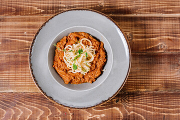Tasty pasta with sauce on wooden background