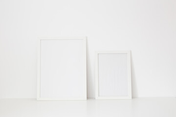 Mockup two frames against white wall.