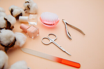 Nail care concept. Professional steel manicure tools on pink table.