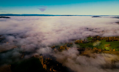 Heavy fog in a valley during sunrise.