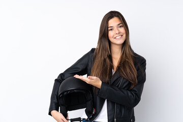 Young woman with a motorcycle helmet over isolated white background extending hands to the side for inviting to come