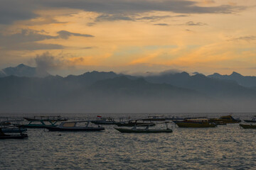 sunset over the sea with boats