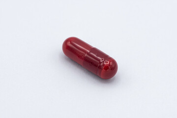medication, pill capsule on white background. red