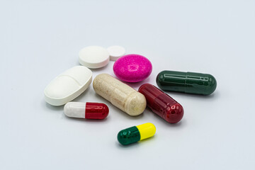 pile of colorful pills on white background