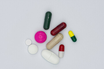 pile of colorful pills on white background