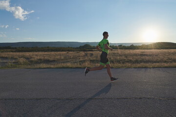 triathlon athlete running on morning trainig
