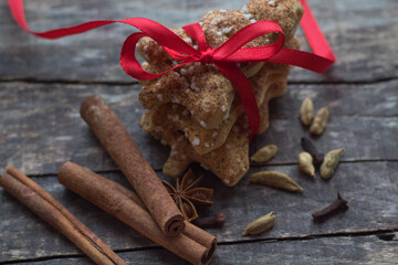 Christmas gingerbread cookies, cinnamon, anise and clove spice on chalkboard background with space for text