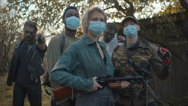 Zombie hunter team in safety mask with weapon and two monsters on background