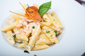 Traditional Italian pasta penne with salmon and creamy sauce.