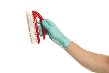 Hand in yellow glove with a red cleaning brush on a white background. Home cleaning concept.