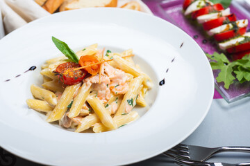 Traditional Italian pasta penne with salmon and creamy sauce.