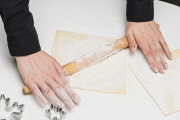 cook the chef rolls the dough for the cookies.