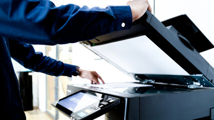 Bussiness man Hand press button on panel of printer, printer scanner laser office copy machine supplies start concept.