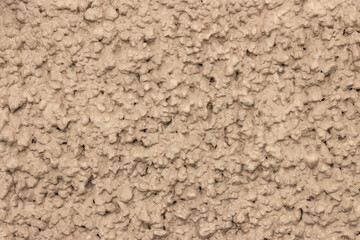 Rough uneven surface of the plastered wall.