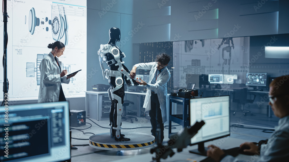 Leinwandbilder In Robotics Technology Development Laboratory Diverse Team of Engineers Work on a Bionics Exoskeleton Prototype. Scientists Design Powered Armor Suit to Help Disabled People and Hard Labor Workers