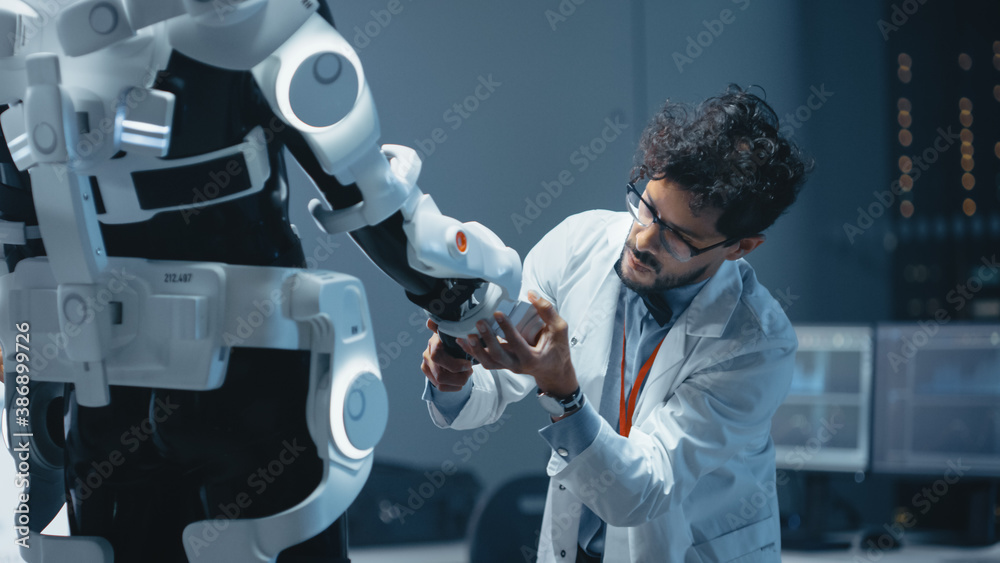Aufkleber in robotics development laboratory: top male scientist works on a bionics exoskeleton prototype. tea
