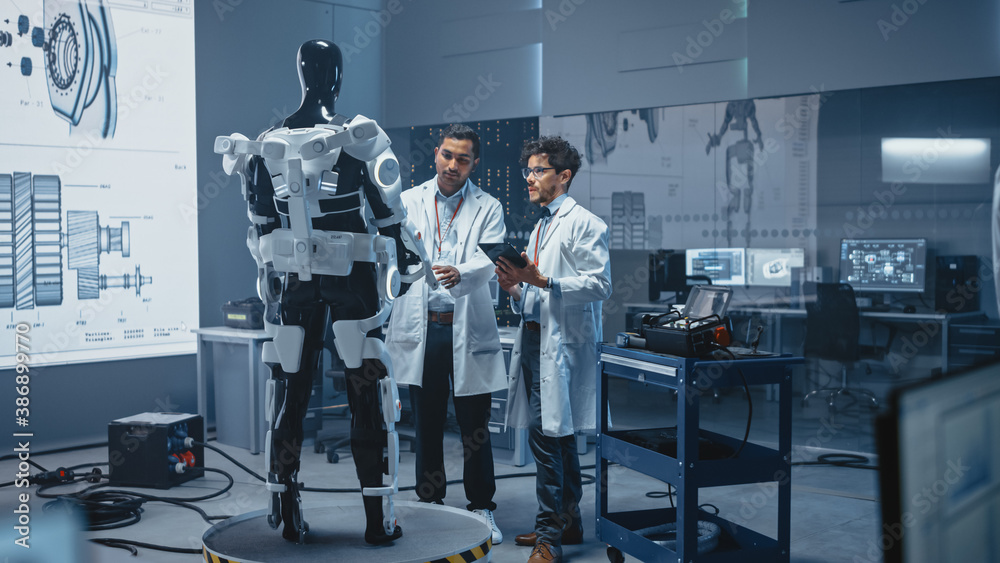 Leinwandbilder In Robotics Development Laboratory International Team of Engineers and Scientists Work on Robotics Exoskeleton Prototype. Designing Powered Exosuit to Help Disabled People Walk, Workers to Lift Goods