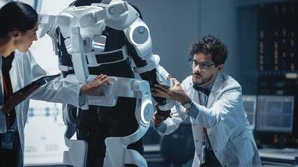 In Robotics Development Laboratory: Chief Female Engineer and Top Male Scientist Work on a Bionics...