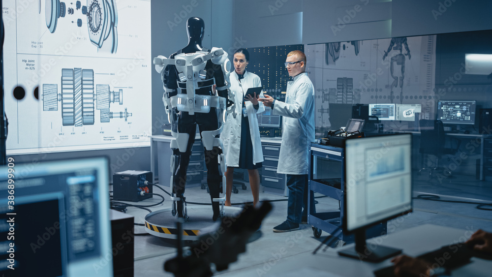 Aufkleber in robotics development laboratory: chief female engineer and top male scientist work on a bionics e