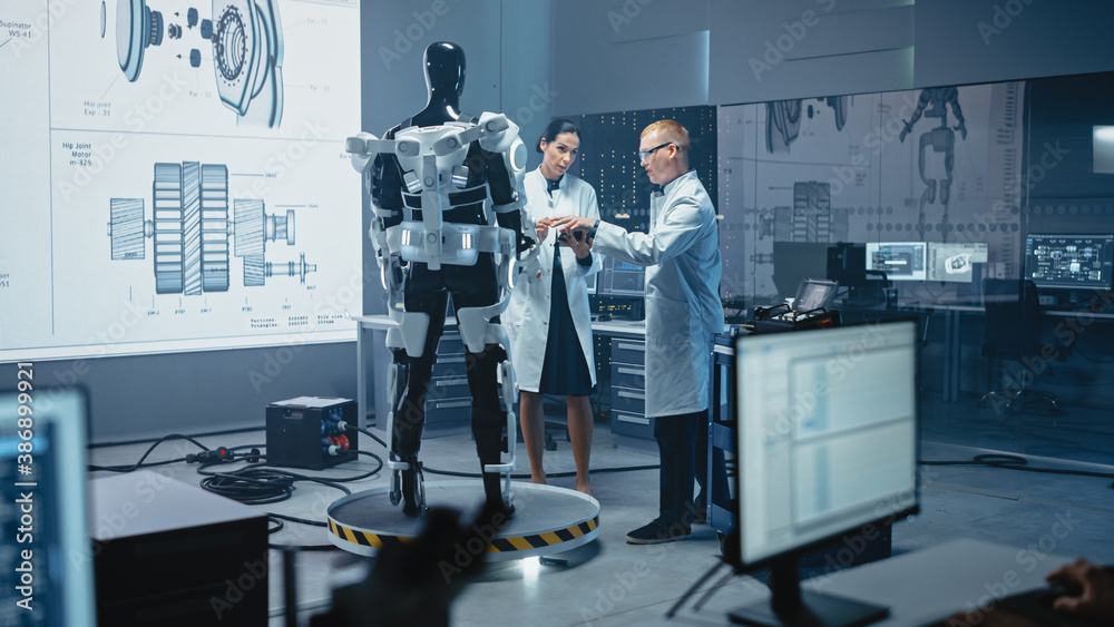Poster in robotics development laboratory: chief female engineer and top male scientist work on a bionics e