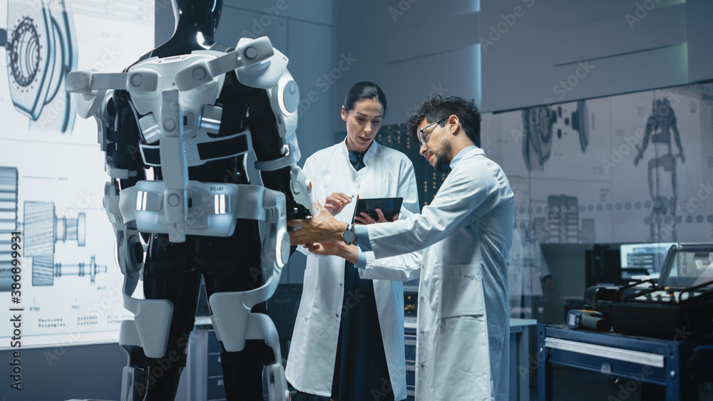 Aufkleber In Robotics Development Laboratory: Chief Female Engineer and Top Male Scientist Work on a Bionics Exoskeleton Prototype. Designing Powered Exosuit to Help Disabled People, Hard Labor Workers