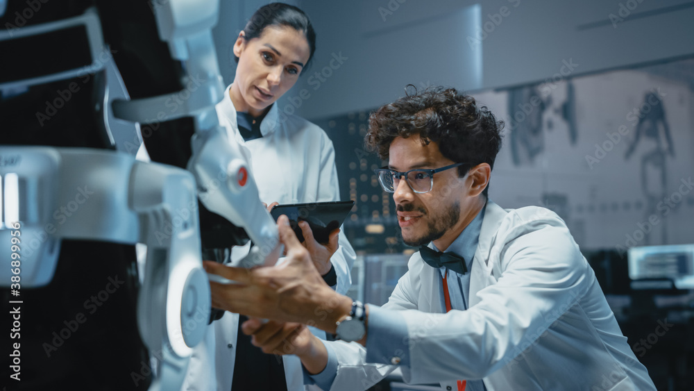 Aufkleber In Robotics Development Laboratory: Chief Female Engineer and Top Male Scientist Work on a Bionics Exoskeleton Prototype. Designing Powered Exosuit to Help Disabled People, Hard Labor Workers
