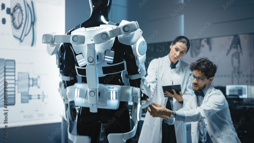 Poster in robotics development laboratory: chief female engineer and top male scientist work on a bionics e