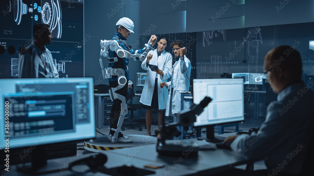 Leinwandbilder In Robotics Development Laboratory: Engineers and Scientists Work on a Bionics Exoskeleton Prototype with Person Testing it. Designing Wearable Exosuit to Help Disabled People, Warehouse Workers