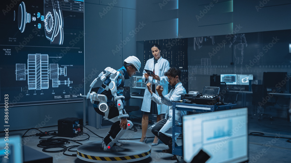 Leinwandbilder In Robotics Development Laboratory: Engineers and Scientists Work on a Bionics Exoskeleton Prototype with Person Testing it and Doing Sit-ups. Designing Wearable Exosuit to Help Disabled People.