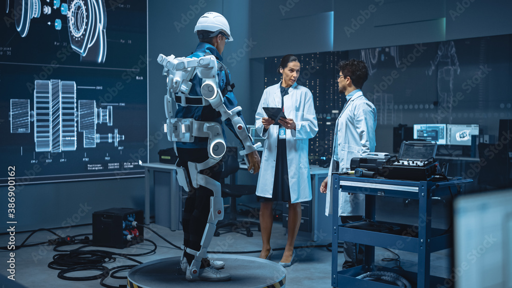 Leinwandbilder In Robotics Development Laboratory: Engineers and Scientists Work on a Bionics Exoskeleton Prototype with Person Testing it. Designing Wearable Exosuit to Help Disabled People, Warehouse Workers