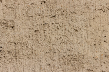 Rough uneven surface of the plastered wall.
