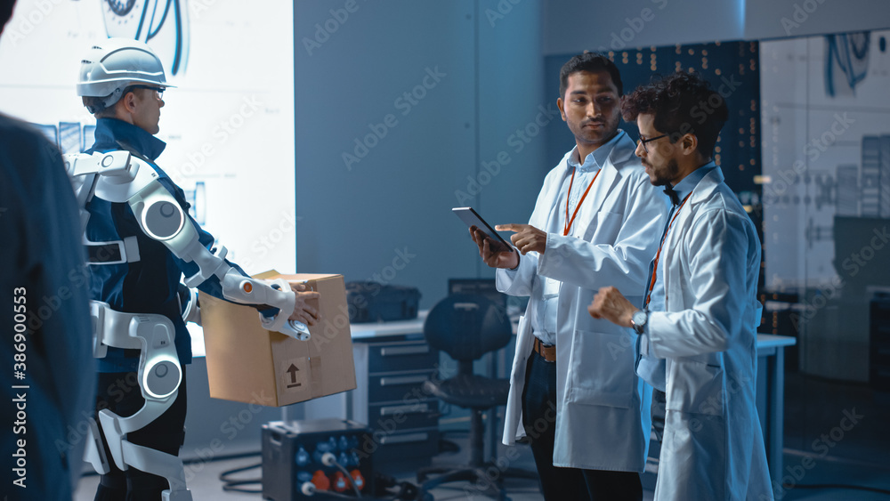 Leinwandbilder in development laboratory: engineers look at robotics exoskeleton prototype presentation with person