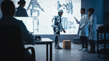 In Development Laboratory: Engineers Look at Robotics Exoskeleton Prototype Presentation with...