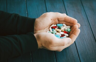 Humans hands with different kind of pills. Man holding pills. Hands with medicine. - 386900581
