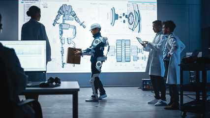 In Development Laboratory: Engineers Look at Robotics Exoskeleton Prototype Presentation with...