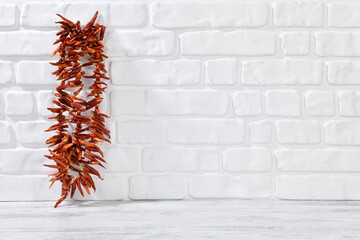 Bunch of red hot chili pepper on decorative stone wall background 
