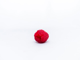 Ripe red juicy raspberry on white background