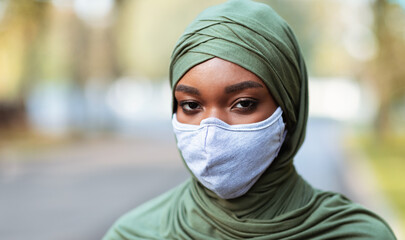 Black Muslim Lady In Protective Face Mask Posing Standing Outside