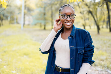 portrait of a beautiful young african american woman smiling and staying outdoors