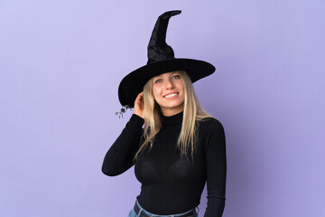 Young woman with witch costume over isolated background having doubts