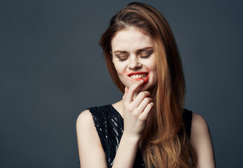 Charming lady in black dress and closed eyes evening makeup portrait