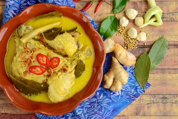Opor ayam, chicken cooked in coconut milk from Indonesia, from Central Java. Popular dish for lebaran or Eid al-Fitr. Flat lay
