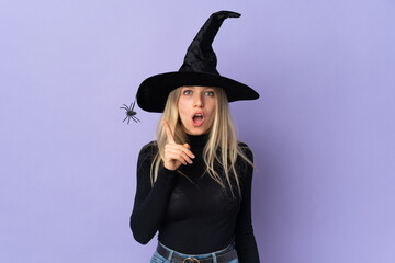 Young woman with witch costume over isolated background intending to realizes the solution while lifting a finger up