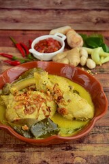 Opor ayam, chicken cooked in coconut milk from Indonesia, from Central Java, served with sambal. Popular dish for lebaran or Eid al-Fitr